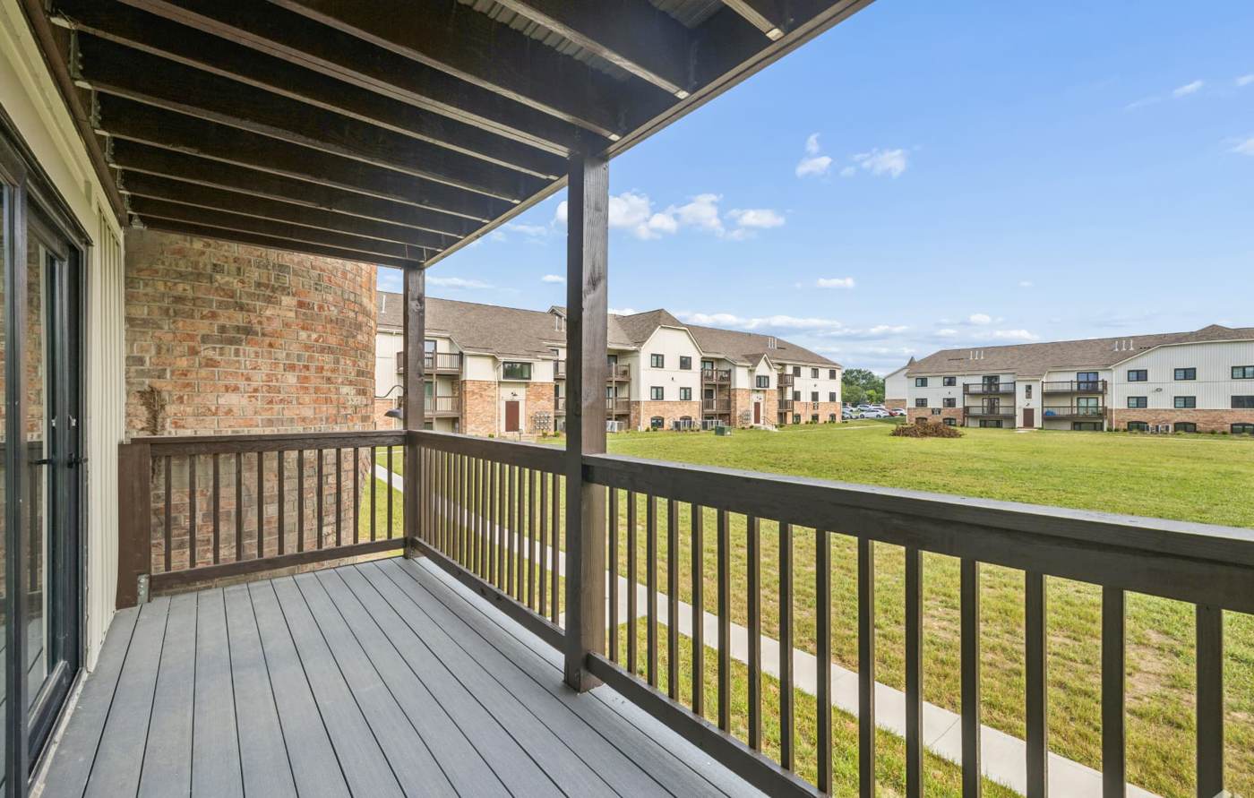 Covered balcony with brick accents facing the courtyard