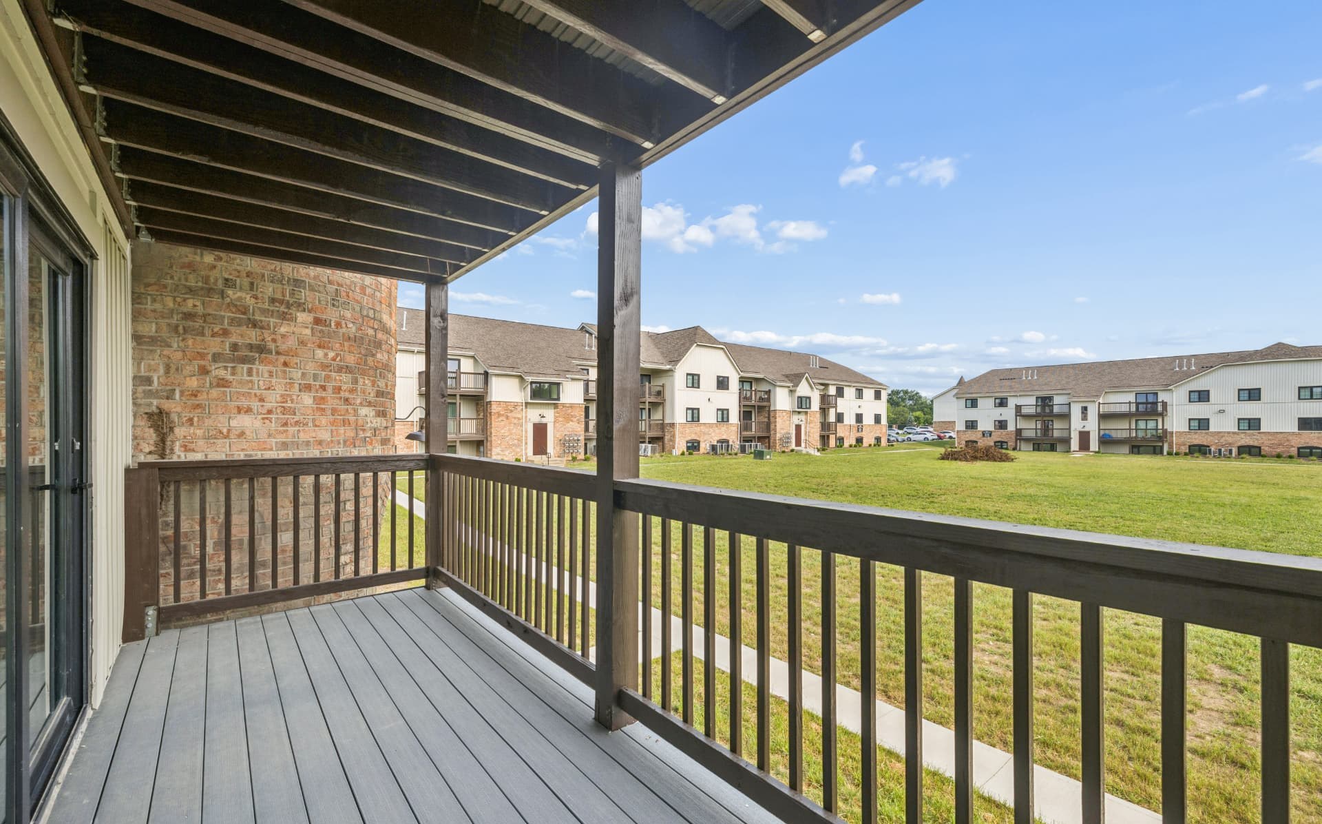 Private covered balcony overlooking the community lawn