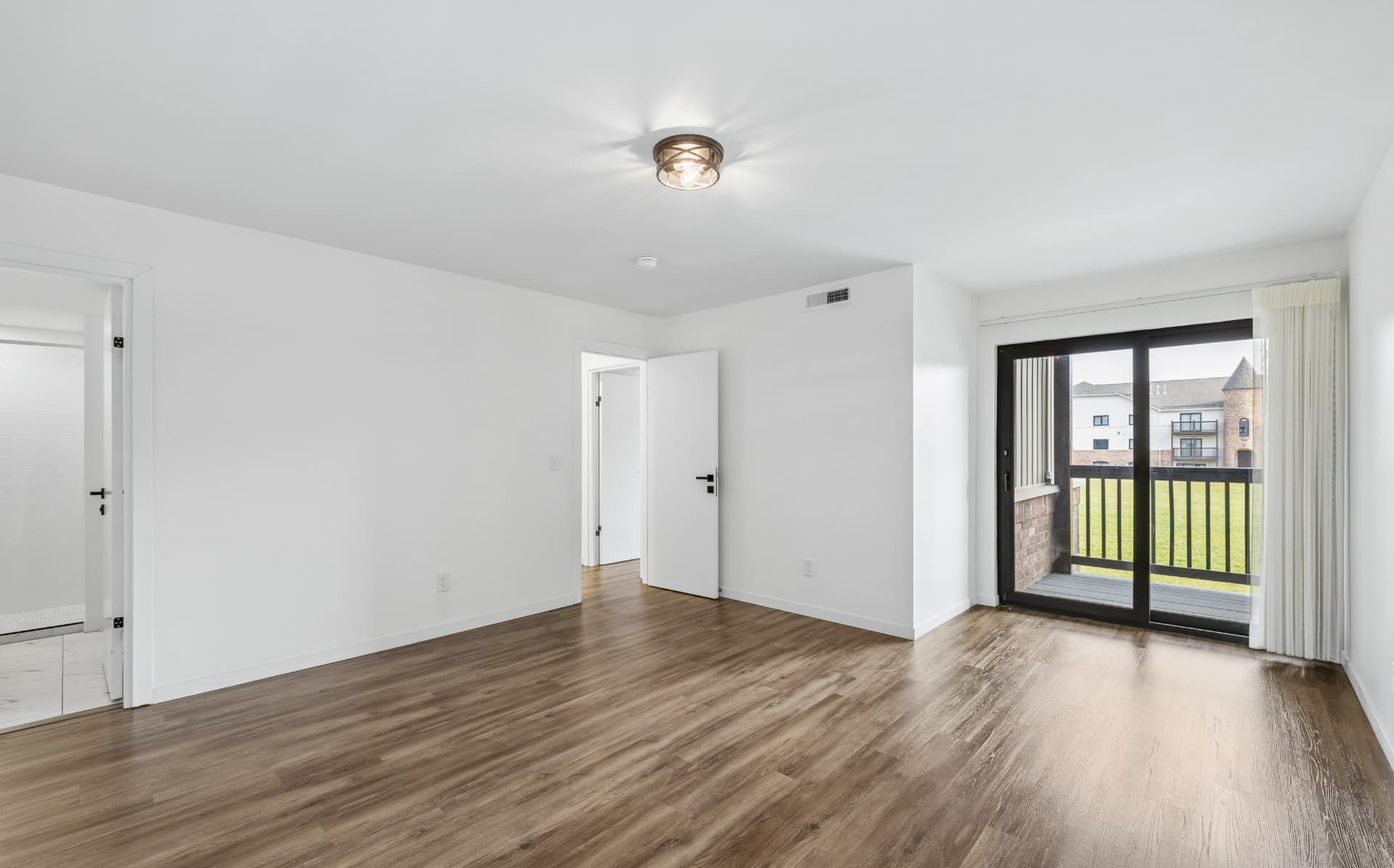 Open living area with private balcony and courtyard views