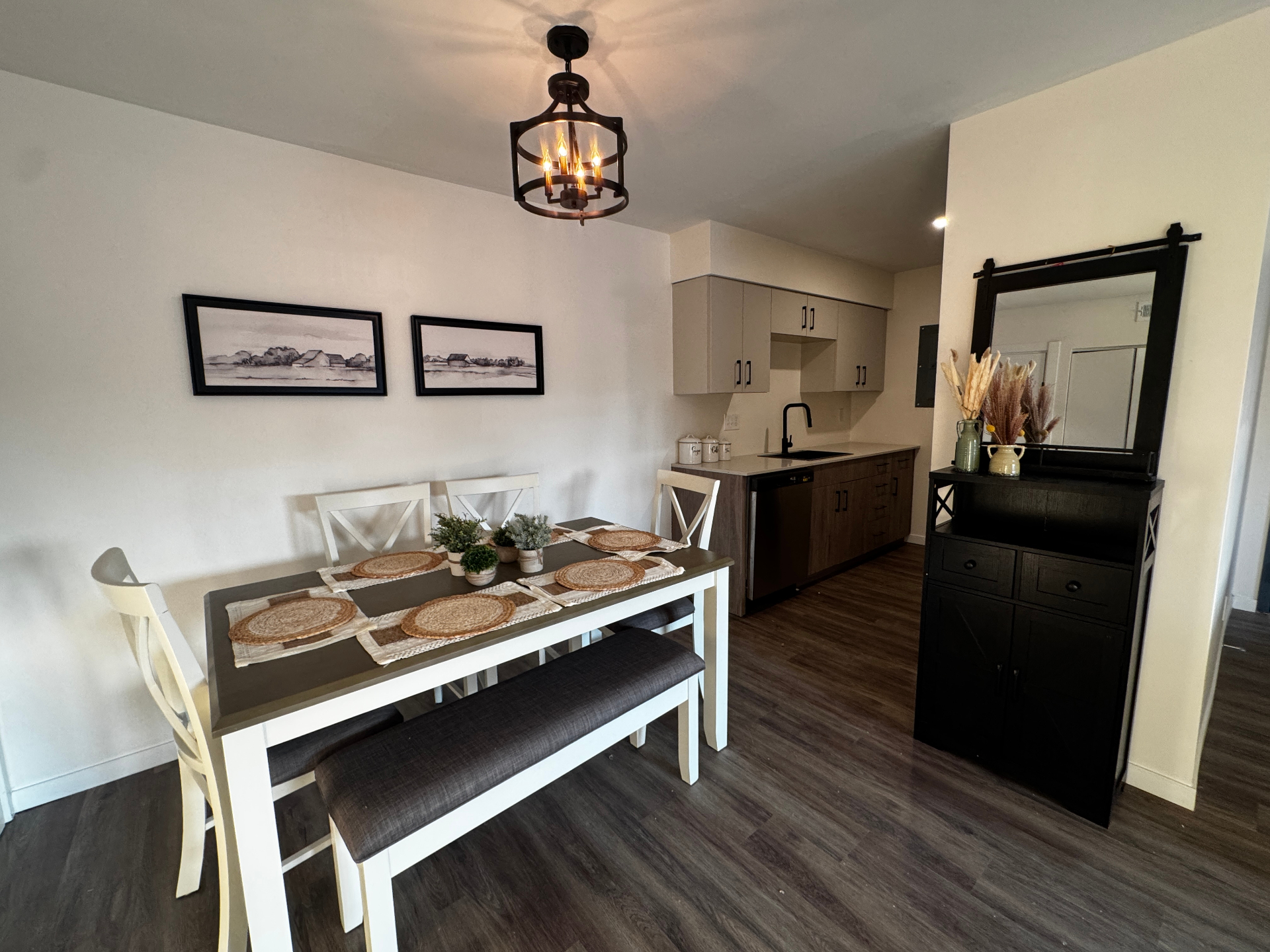 Dining area with cage chandelier and open kitchen